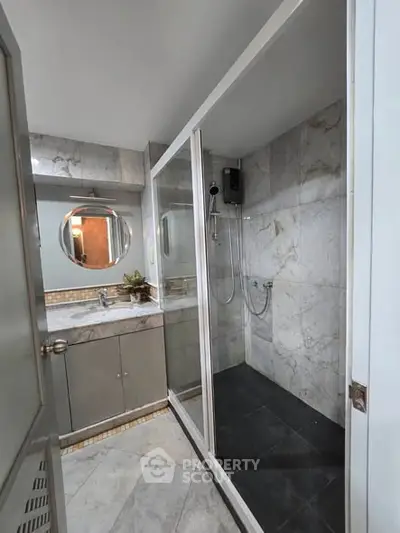 Modern bathroom with sleek shower and stylish vanity in a contemporary home.