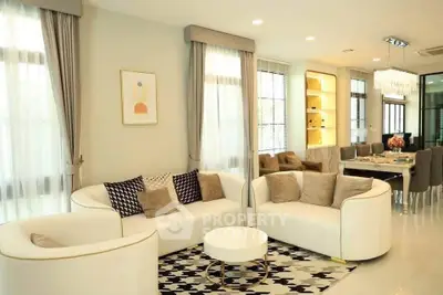 Elegant living room with modern decor and dining area, featuring stylish furniture and ambient lighting.