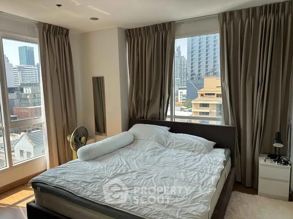 Spacious bedroom with city view and natural light in modern apartment