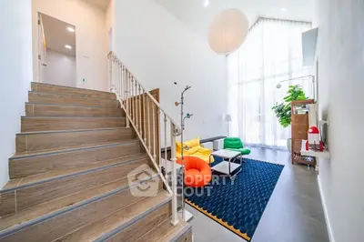 Spacious modern living room with high ceilings and colorful furniture