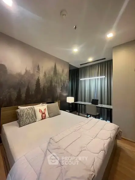 Modern bedroom with forest-themed wall art and cozy lighting