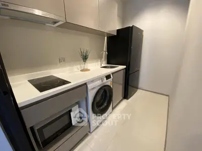 Modern kitchen with sleek appliances and compact design