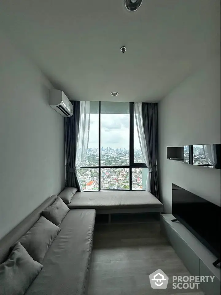 Modern living room with panoramic city view and sleek furnishings