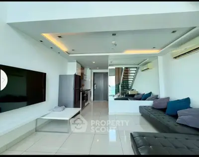 Modern living room with sleek design and open kitchen layout