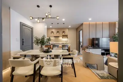 Luxurious open-plan living and dining area with modern decor and elegant lighting.