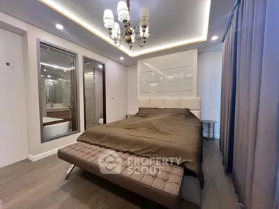 Luxurious bedroom with elegant chandelier and modern decor