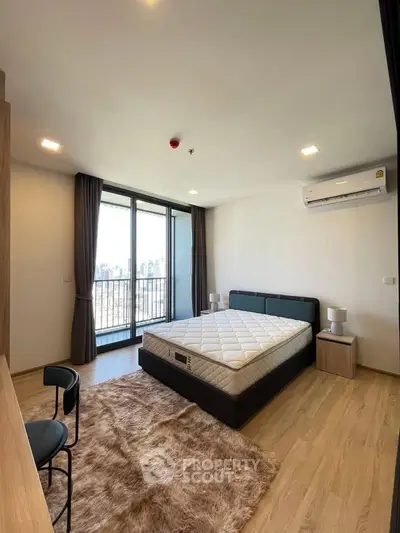 Spacious bedroom with balcony view in modern apartment
