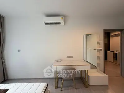 Modern bedroom with sleek furniture and air conditioning unit, ideal for comfortable living.