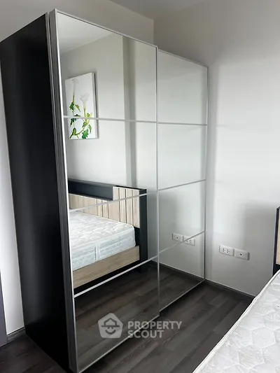 Modern bedroom with mirrored wardrobe and stylish decor