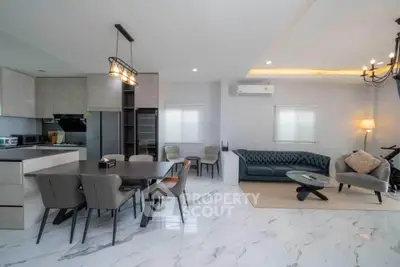 Spacious modern living room with open kitchen and elegant marble flooring