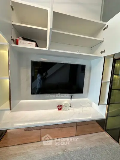 Modern living room with built-in TV unit and open shelving