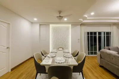 Elegant dining area with modern decor and stylish seating in a spacious living room setting.
