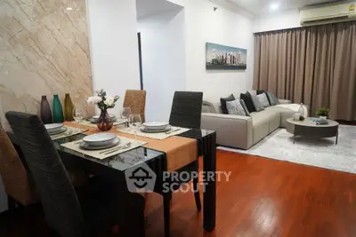 Elegant living room with dining area, featuring modern decor and cozy seating.