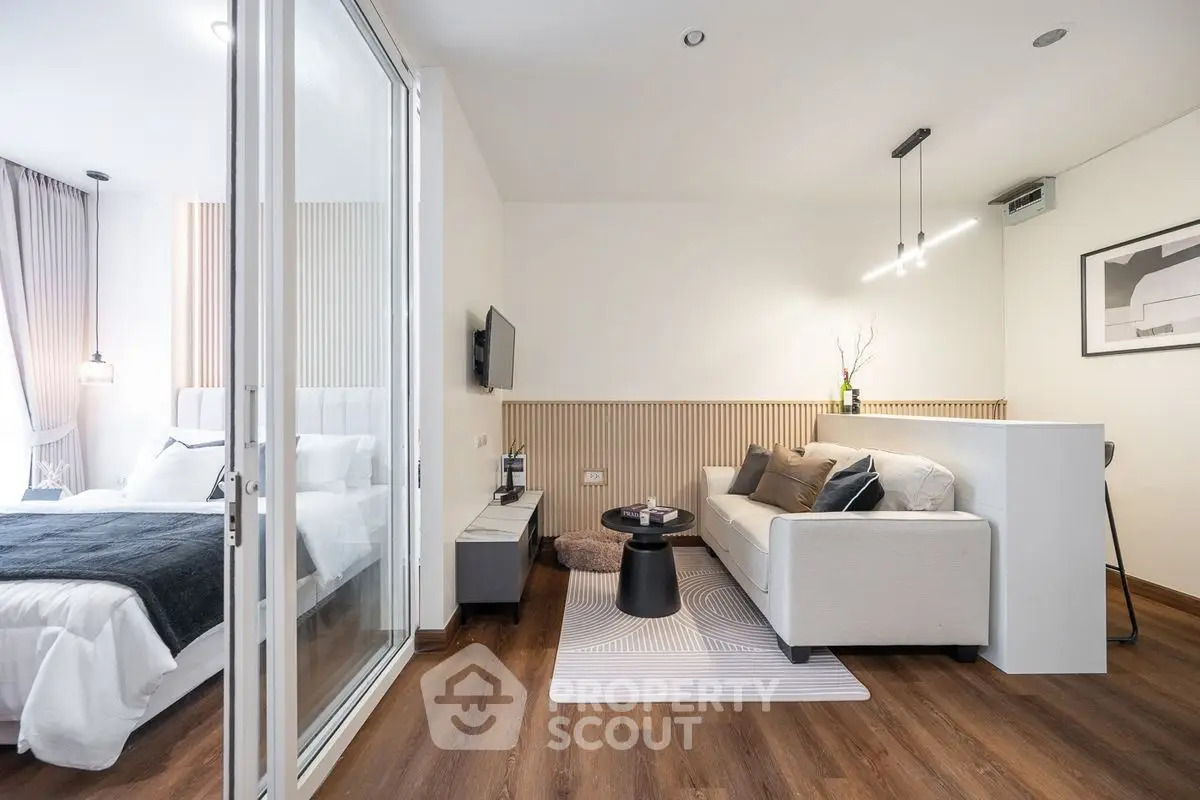 Modern open-plan living room with cozy bedroom and stylish decor