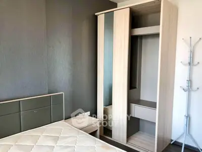 Modern bedroom with sleek wardrobe and stylish headboard in a contemporary apartment.