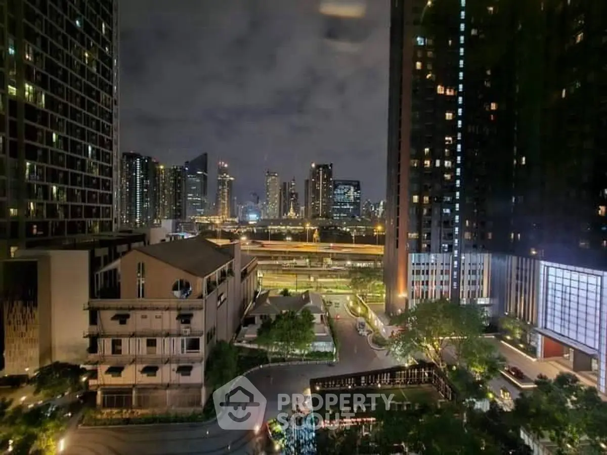 Stunning night view of urban skyline with modern high-rise buildings and city lights.