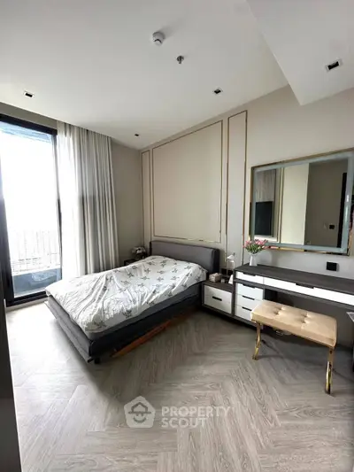 Modern bedroom with elegant decor and large window for natural light