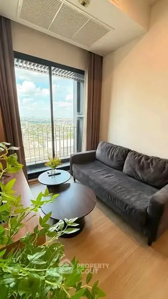 Cozy living room with a stunning view, featuring a comfortable sofa and elegant decor.