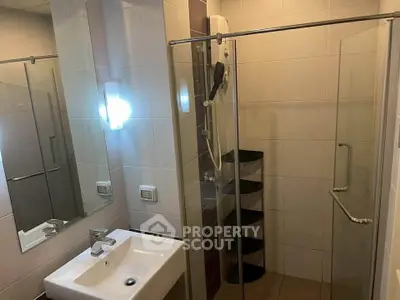 Modern bathroom with glass shower enclosure and sleek sink design