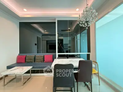 Modern living room with elegant chandelier and stylish furniture