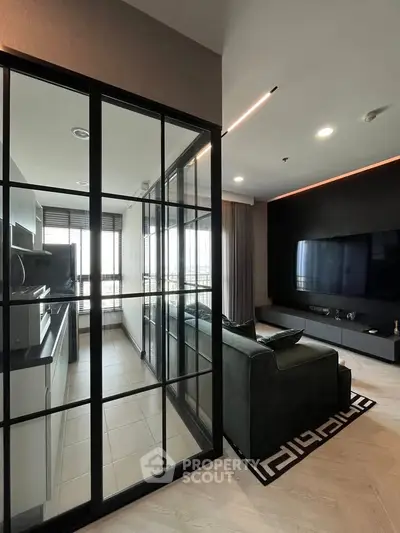Modern living room with glass partition and sleek kitchen design