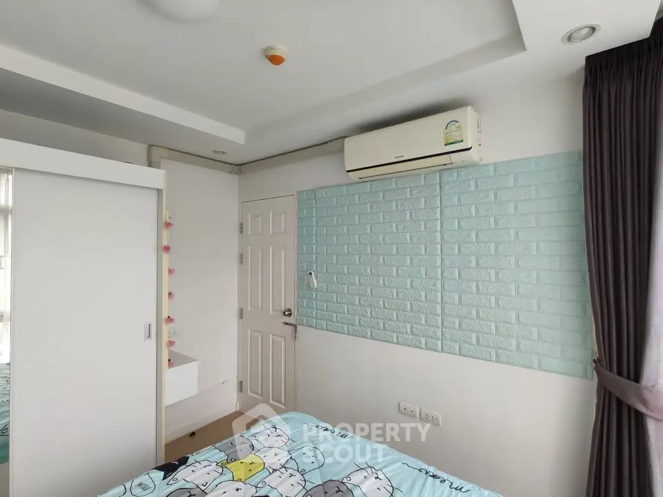 Cozy bedroom with air conditioning and stylish decor in modern apartment