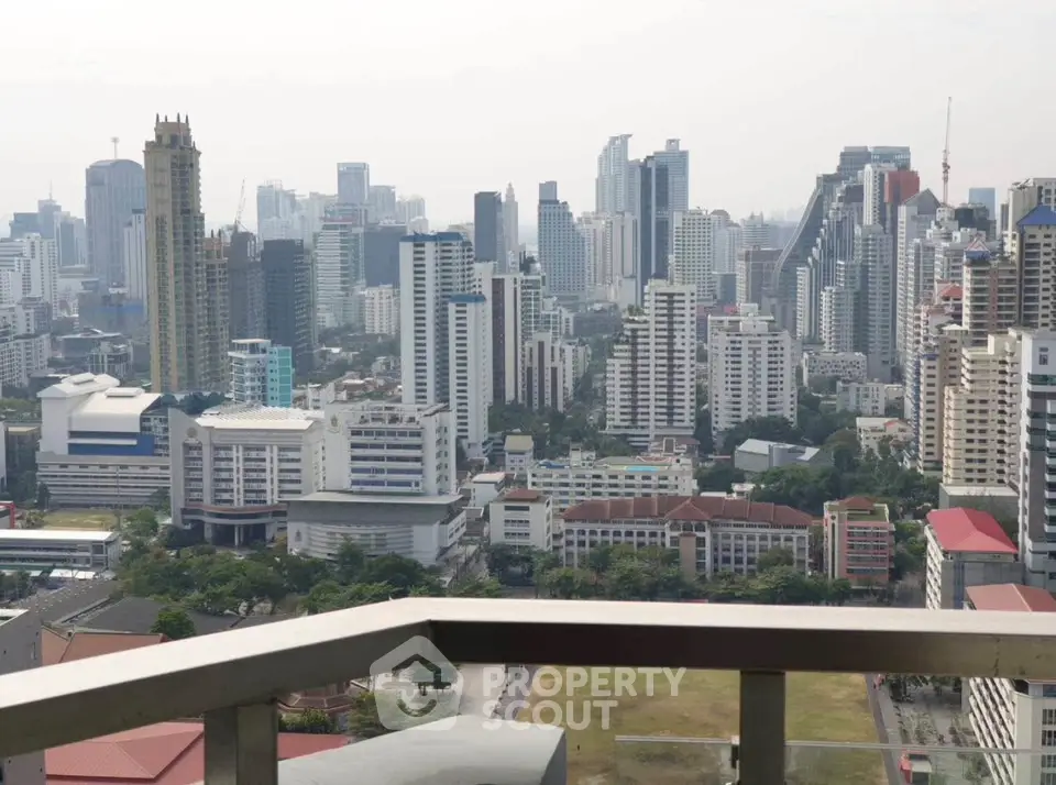 Stunning cityscape view from a high-rise balcony overlooking urban skyline.