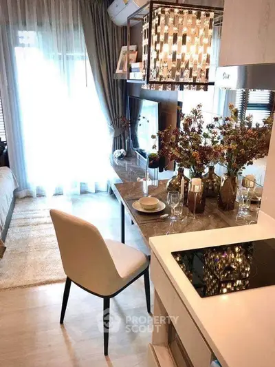 Stylish modern studio apartment with elegant decor and open layout, featuring a cozy dining area and natural light.