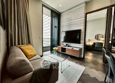 Modern living room with stylish decor and large windows in a high-rise apartment.