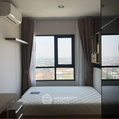 Modern bedroom with city view, featuring large window and sleek design.