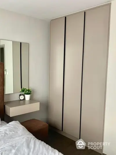 Modern bedroom with sleek wardrobe and minimalist decor