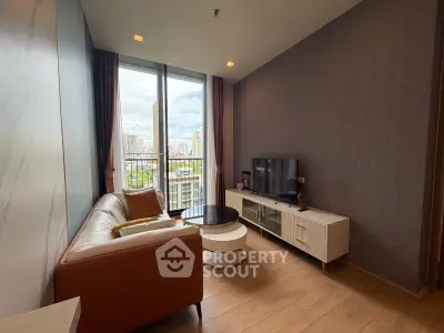 Modern living room with city view, featuring stylish furniture and floor-to-ceiling windows.