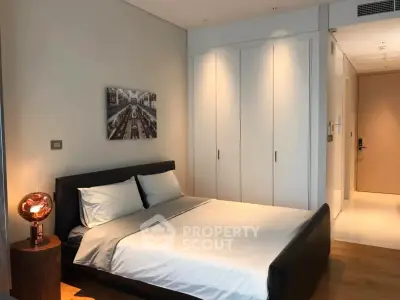 Modern bedroom with sleek design, featuring a comfortable bed and built-in wardrobe, perfect for relaxation.