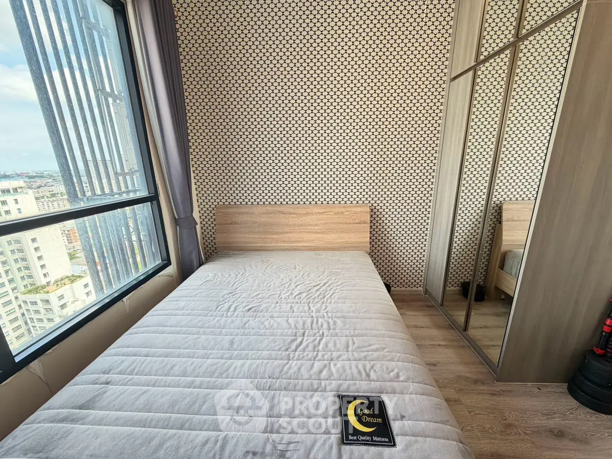Modern bedroom with city view and stylish decor in high-rise apartment.