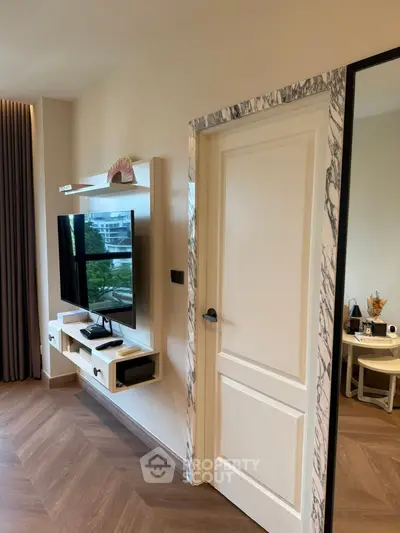 Modern living room with mounted TV and stylish decor