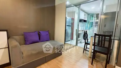 Modern living room with cozy sofa, dining area, and kitchen view in stylish apartment.