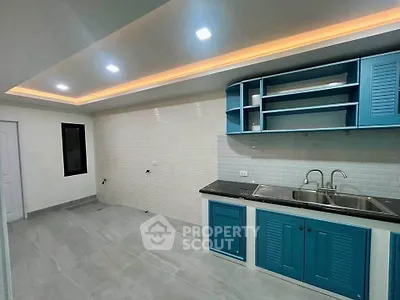Modern kitchen with blue cabinets and sleek lighting, perfect for culinary enthusiasts.
