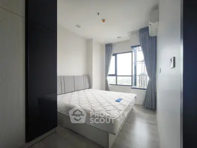 Modern bedroom with large window and minimalist decor