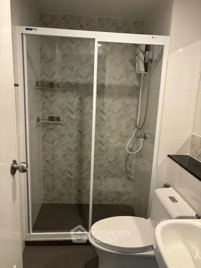 Modern bathroom with glass shower enclosure and sleek fixtures