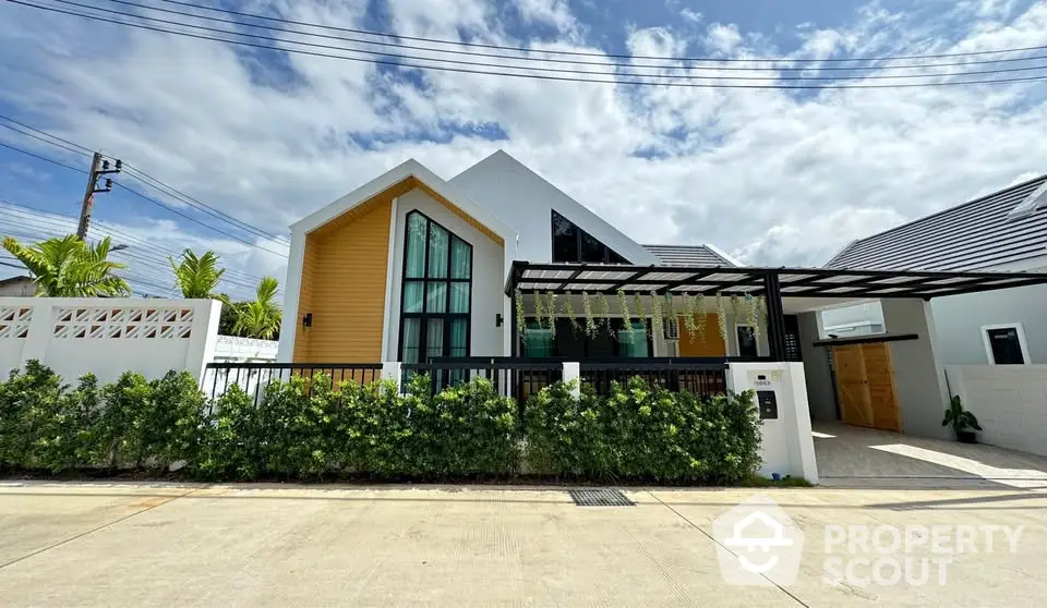 Modern single-story house with unique architecture and lush greenery in a serene neighborhood.