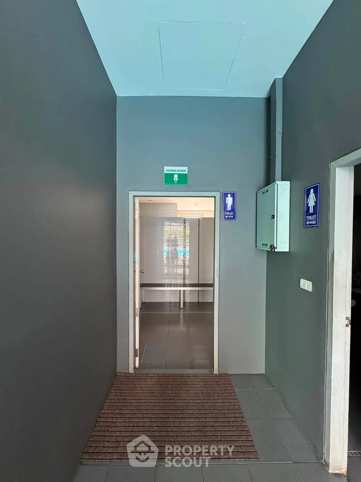 Modern building corridor with restroom signs and sleek design