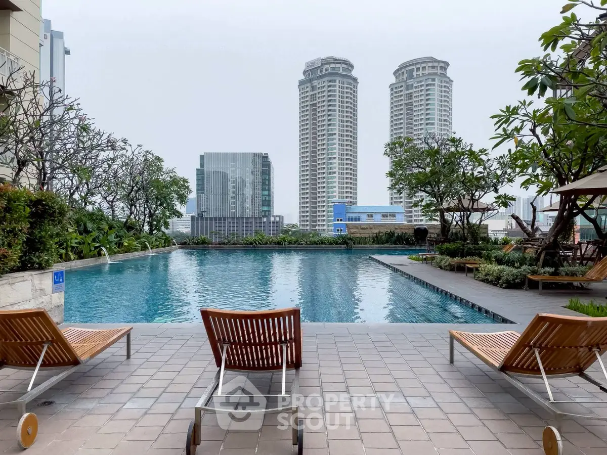 Luxurious rooftop pool with city skyline view and elegant lounge chairs.
