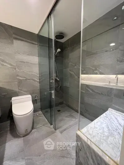Modern bathroom with sleek glass shower and elegant marble accents