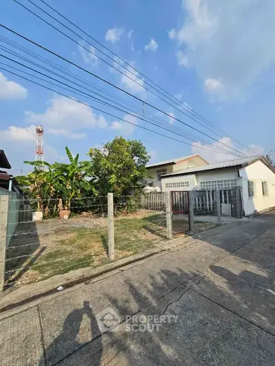 Charming suburban house with spacious yard and lush greenery, perfect for family living.