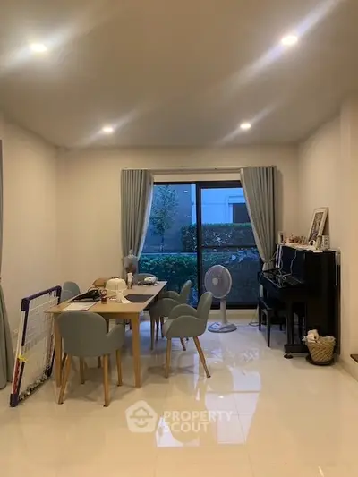 Spacious dining area with modern furniture and large window view