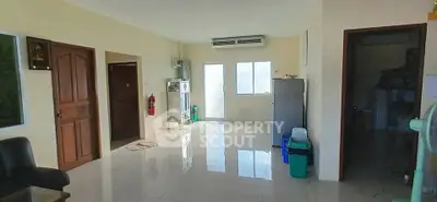 Spacious living area with modern appliances and natural light, perfect for comfortable living.