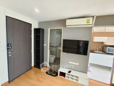 Modern apartment interior with open kitchen and living area, featuring air conditioning and sleek design.