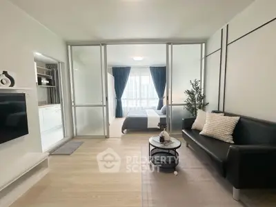 Modern open-plan living room with sleek decor and natural light