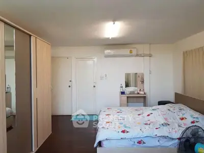 Spacious bedroom with modern decor and ample storage space.