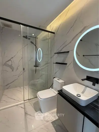 Luxurious modern bathroom with marble tiles and sleek fixtures